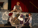 Courtney Trent as Katie Garfield, with Newsies: Grace Ratliff, Elizabeth Thomas, Ruth Thomas, Hannah Williams, Katie Williams.